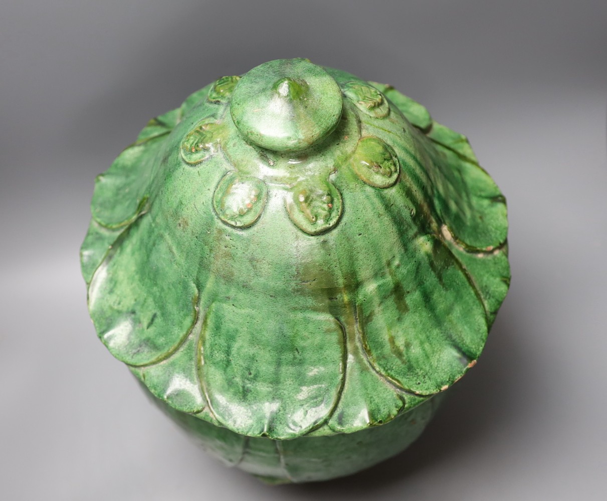 A Buddhist green glazed pottery jar and cover, 10th - 13th century. Thermoluminescence analysis report included, 43cm